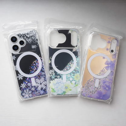 Three phone cases with floral and glitter designs in clear packaging on a light gray background