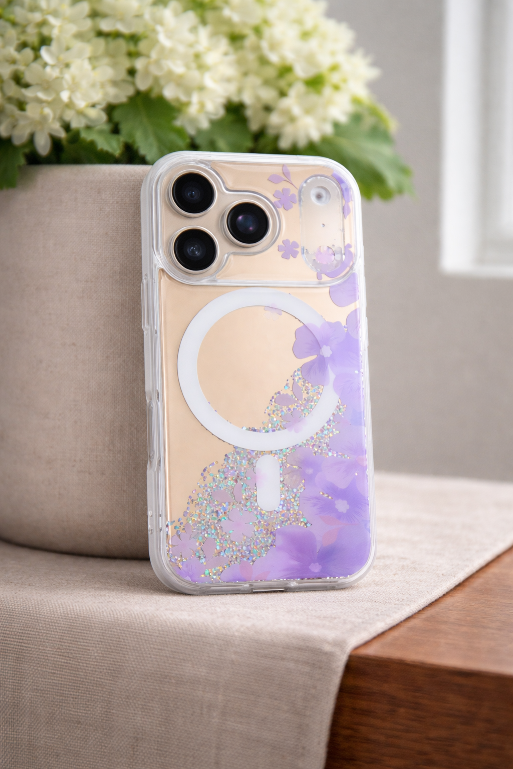 Phone case with floral design on a surface with flowers in the background